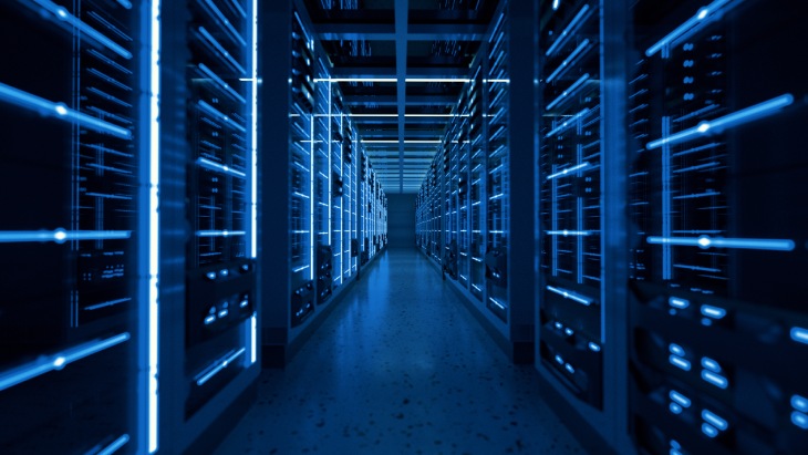 Rows of servers used in darkened hallway in sustainable data center